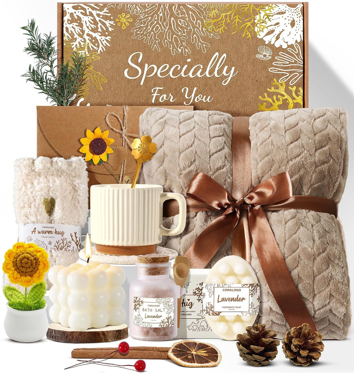 11-piece curated set including bath salts, scented candle, handmade soaps, soft blanket, fuzzy socks, tea set (mug + spoon + coaster), dried flower bouquet, sunflower potted decor, and blank greeting card