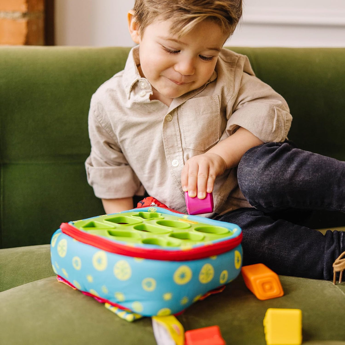 9 textured shape blocks sized for little hands to drop through matching holes
