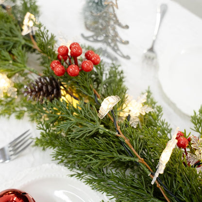 integrated decorative elements: cedar-style branches, pine cones, and red berries that resist falling or fading